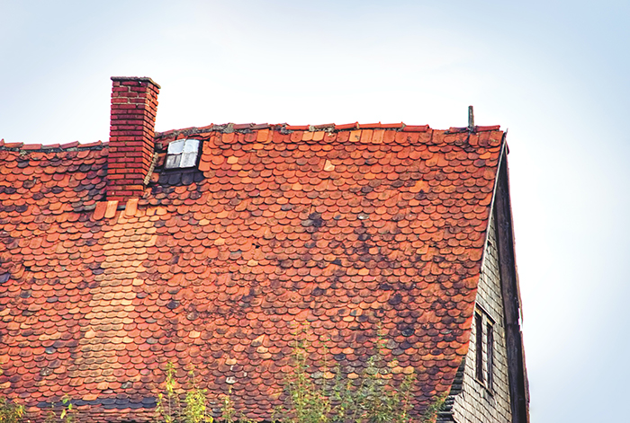 Image of roof in need of repair. Be sure to check your roof now before winer winds can do damage