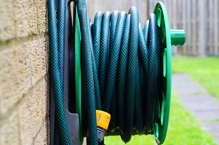 Image of garden hose. Turn off exterior spigots before freezing weather sets in