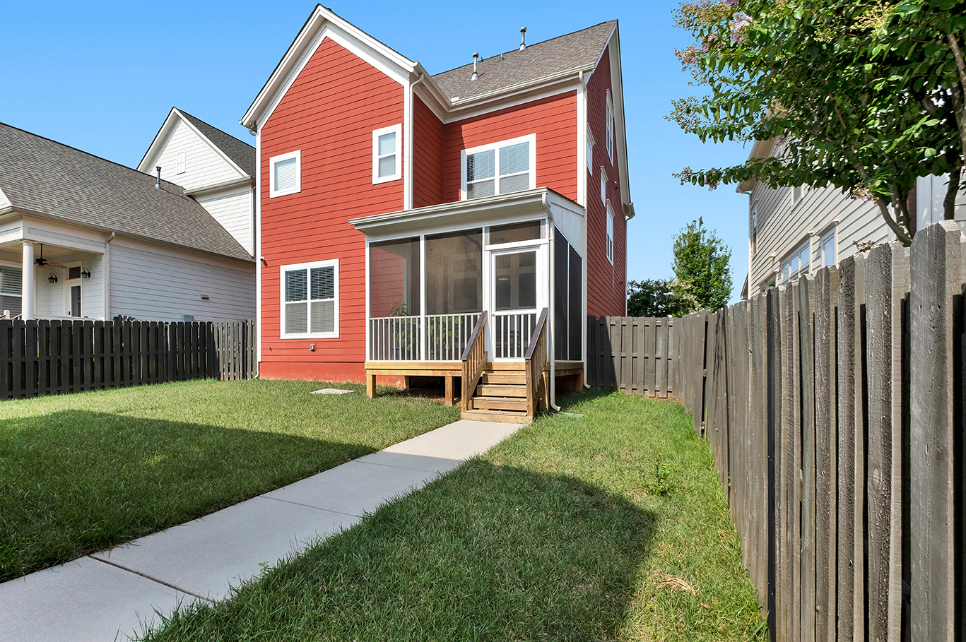 A picture of a small, red house with James Hardie siding